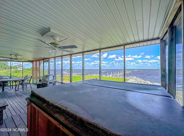 unfurnished sunroom with ceiling fan and a wealth of natural light