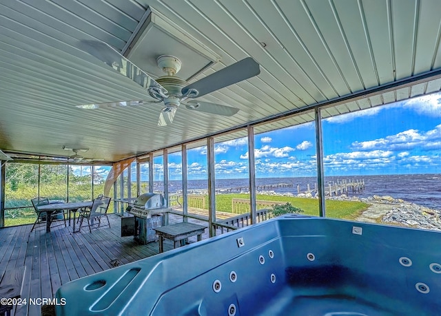 unfurnished sunroom featuring ceiling fan