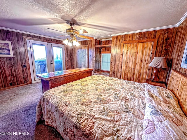 unfurnished bedroom with access to exterior, a textured ceiling, carpet, and crown molding