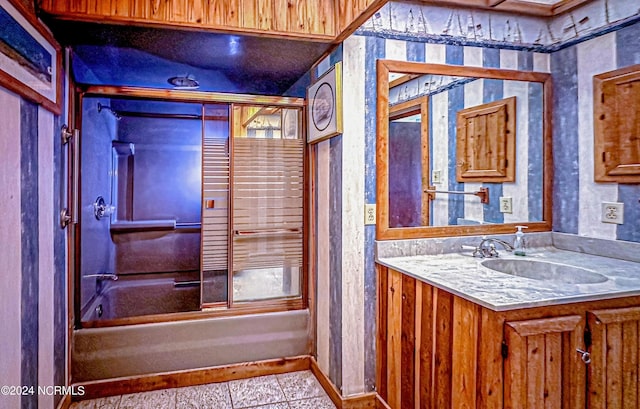 bathroom featuring tub / shower combination, vanity, baseboards, and tile patterned floors