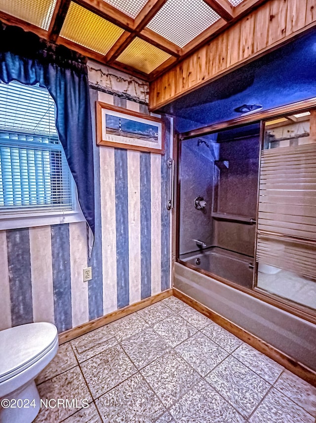 full bath featuring toilet, baseboards, and bath / shower combo with glass door