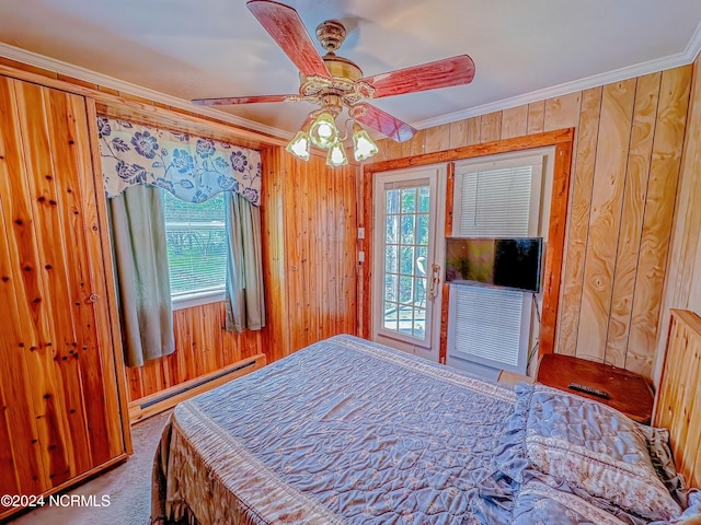 bedroom with ornamental molding, baseboard heating, carpet flooring, and wooden walls