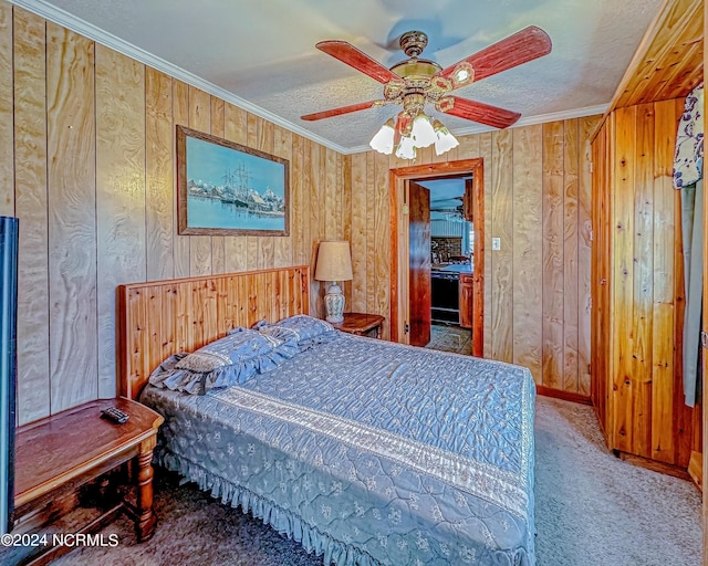 bedroom with a textured ceiling, carpet floors, and crown molding