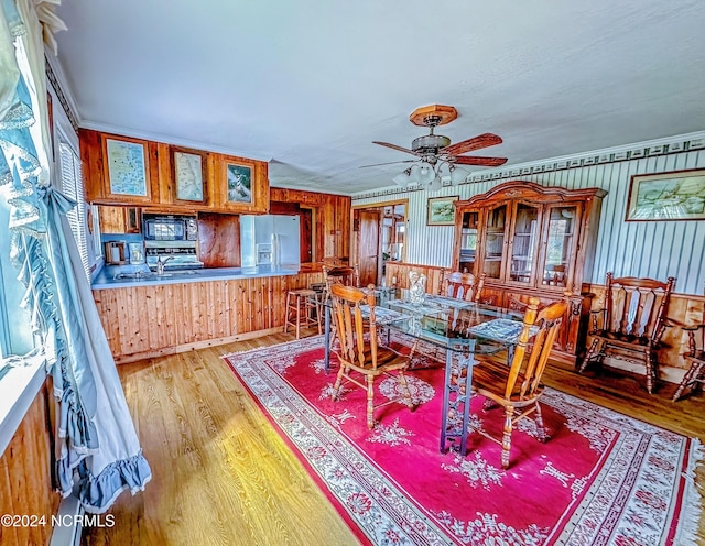 dining space featuring ornamental molding, wood finished floors, and a ceiling fan