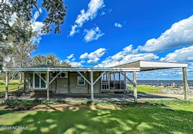 rear view of property featuring a lawn