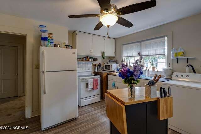 kitchen with hardwood / wood-style flooring, white appliances, white cabinetry, washer / dryer, and ceiling fan