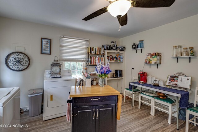 kitchen with light hardwood / wood-style floors, separate washer and dryer, ceiling fan, a kitchen island, and butcher block counters