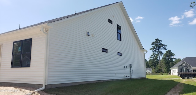 view of side of property with a yard