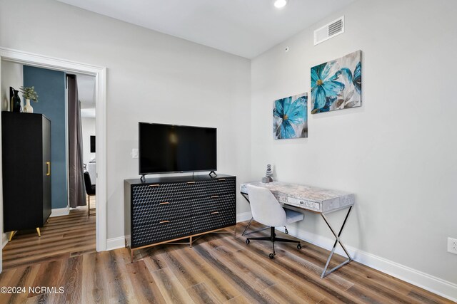 office with visible vents, baseboards, and wood finished floors