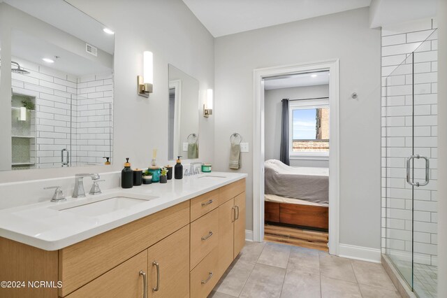 ensuite bathroom with tile patterned floors, visible vents, a stall shower, ensuite bathroom, and a sink