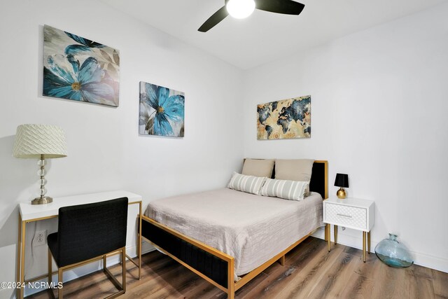 bedroom with wood finished floors and a ceiling fan