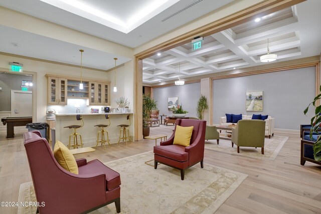 interior space featuring coffered ceiling, recessed lighting, ornamental molding, light wood-style floors, and beamed ceiling