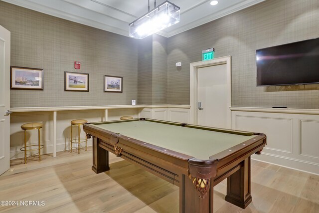 recreation room featuring light wood finished floors, wallpapered walls, and crown molding