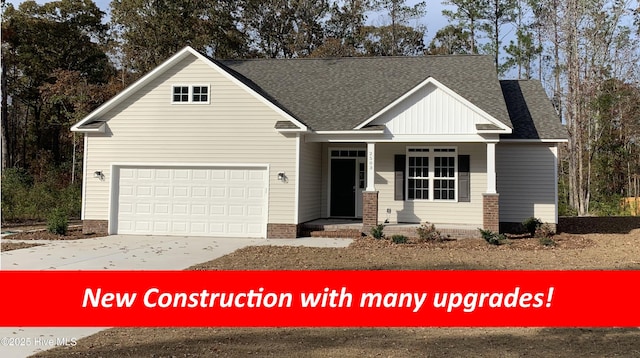 view of front of property with a porch and a garage