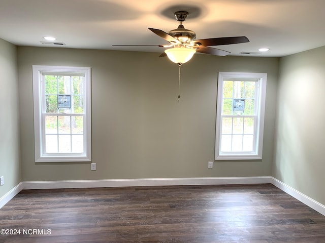 spare room with ceiling fan and dark hardwood / wood-style floors