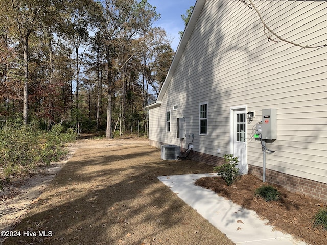 view of side of property with central AC