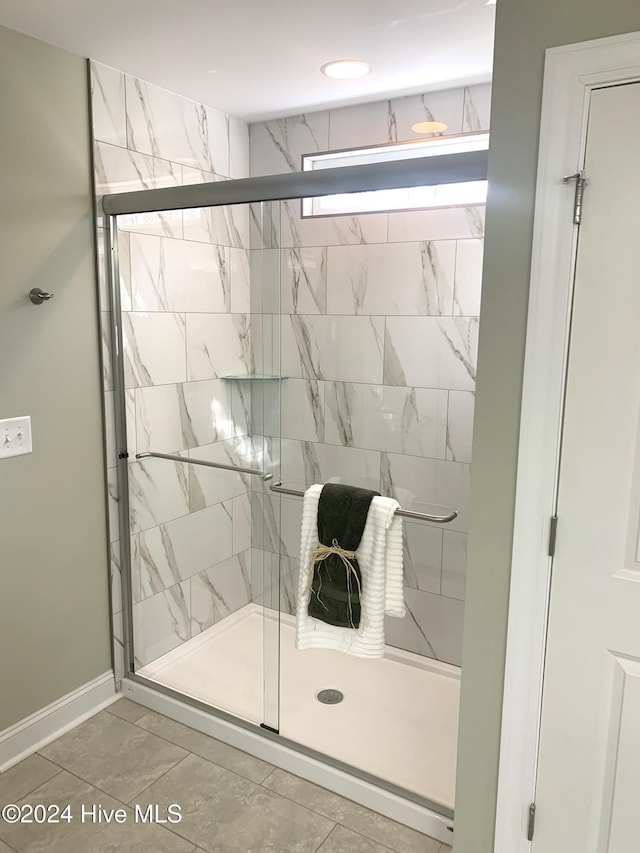 bathroom with a shower with door