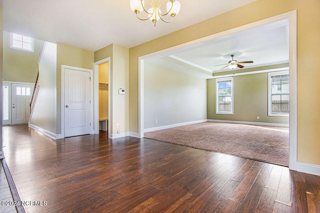 unfurnished room featuring dark hardwood / wood-style flooring and ceiling fan with notable chandelier