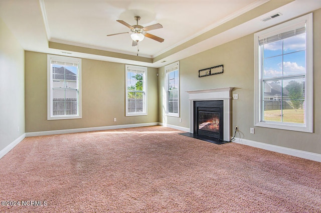 unfurnished living room featuring crown molding, ceiling fan, carpet flooring, and a raised ceiling