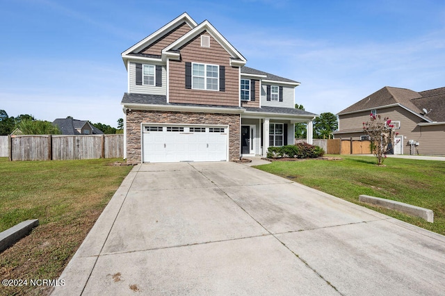 view of front of property with a front yard and a garage