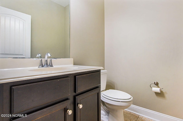 bathroom featuring vanity, toilet, and tile patterned floors