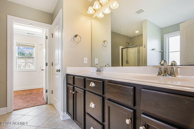 bathroom with vanity, walk in shower, and tile patterned flooring