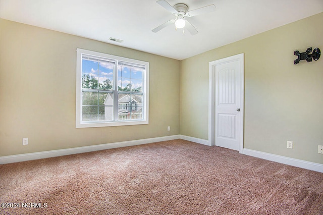 unfurnished room with carpet and ceiling fan