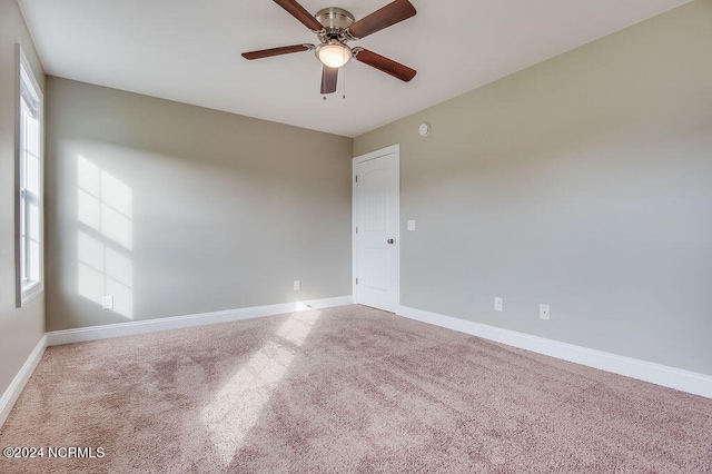 empty room with ceiling fan and carpet flooring