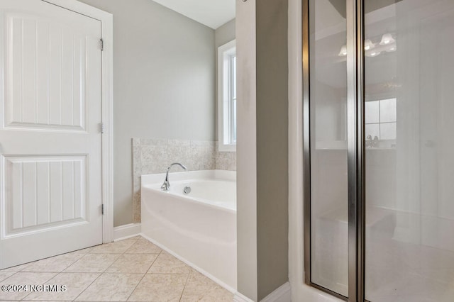 bathroom featuring plus walk in shower and tile patterned floors