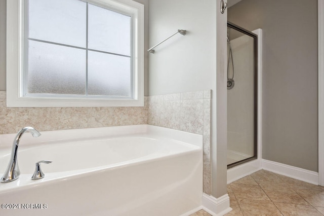 bathroom featuring plenty of natural light, tile patterned floors, and separate shower and tub