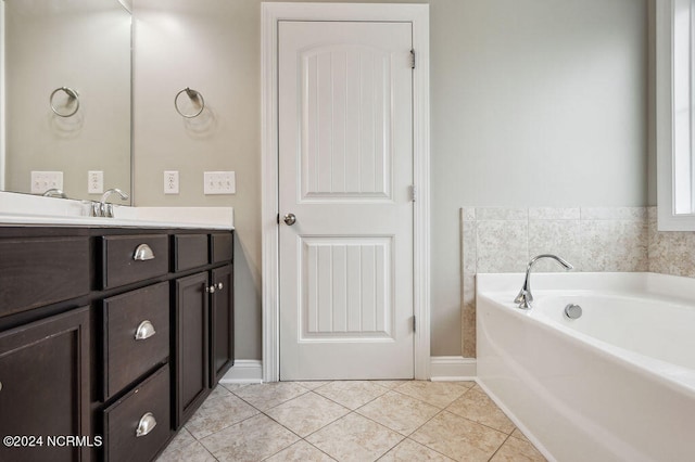 bathroom with vanity, a tub to relax in, and tile patterned flooring