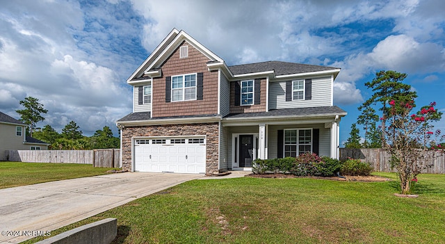 craftsman inspired home with a front lawn and a garage