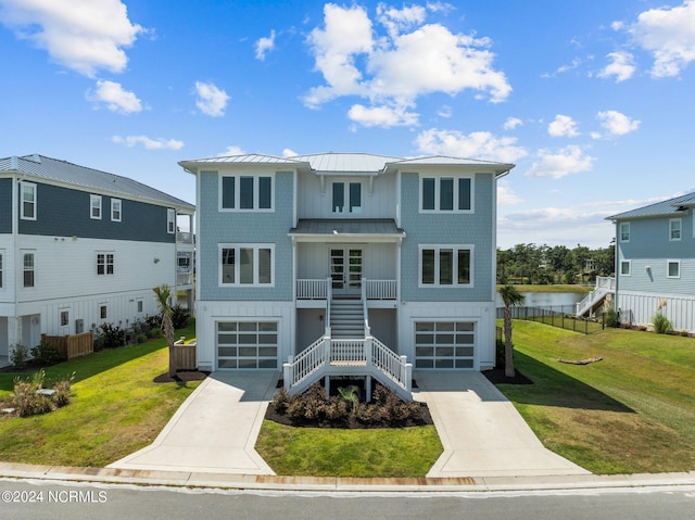 view of front of home featuring a water view, a garage, and a front yard