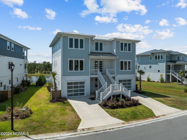 view of front facade featuring a front yard, a water view, and a garage