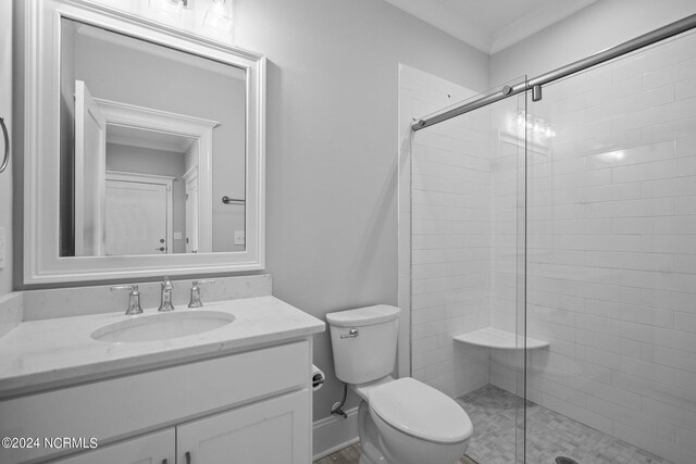 bathroom featuring ornamental molding, vanity, toilet, and an enclosed shower