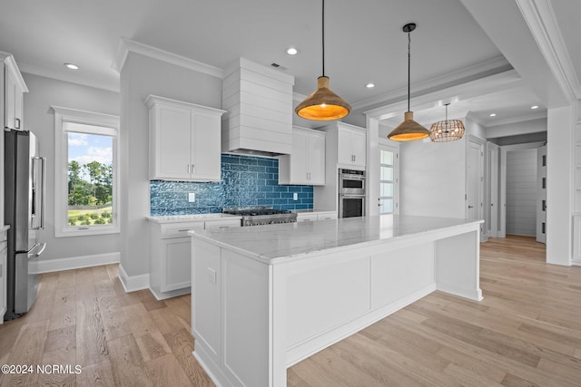 kitchen featuring light hardwood / wood-style flooring, appliances with stainless steel finishes, white cabinetry, and a kitchen island