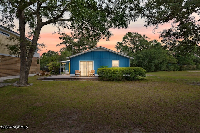 view of front facade with a yard and a patio area