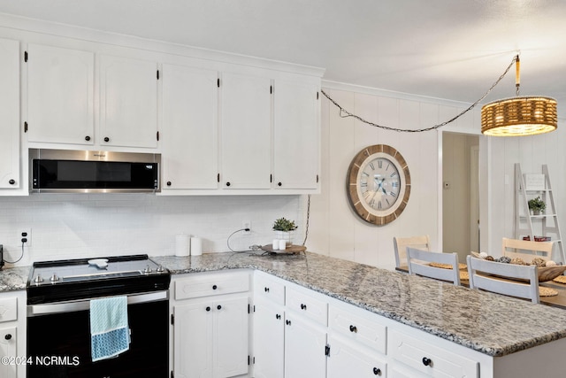 kitchen featuring appliances with stainless steel finishes, backsplash, light stone countertops, and white cabinets