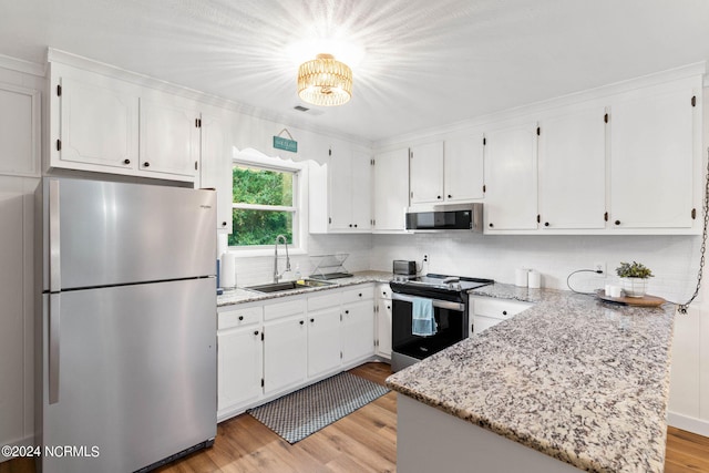 kitchen featuring light hardwood / wood-style floors, stainless steel appliances, sink, and white cabinetry