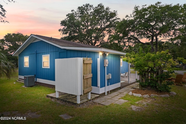 exterior space featuring a lawn and central AC