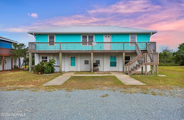 view of front of house with a porch and a lawn