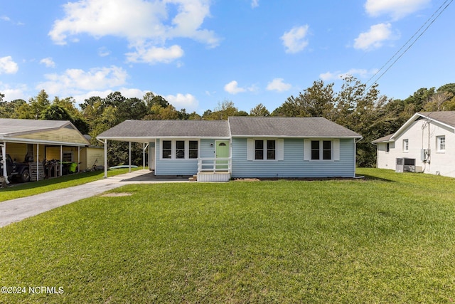 view of front of home featuring a front lawn, a carport, and central air condition unit