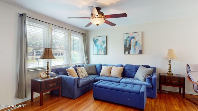 living room with wood-type flooring and ceiling fan