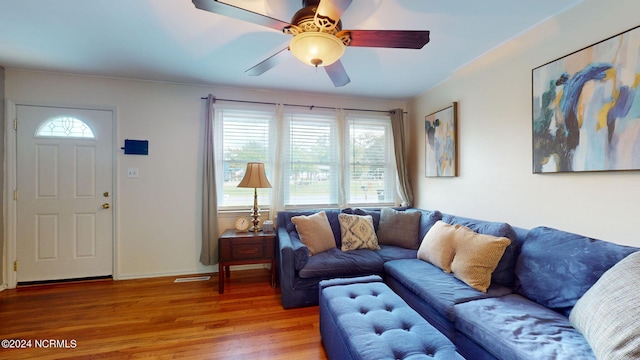 living room with a healthy amount of sunlight, ceiling fan, and wood-type flooring