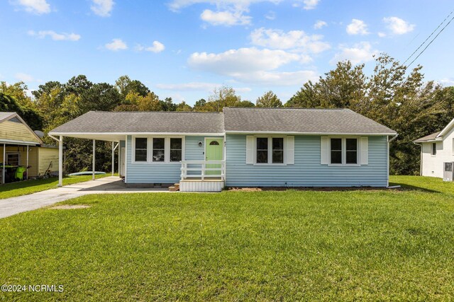 single story home featuring a carport and a front yard