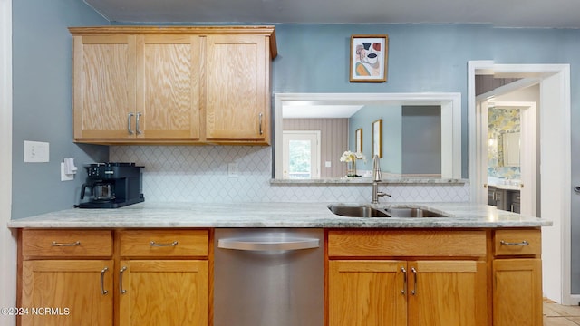 kitchen featuring dishwasher, sink, and tasteful backsplash