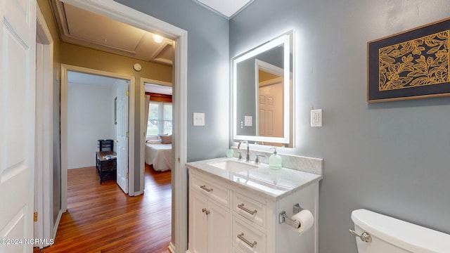 bathroom featuring hardwood / wood-style floors, vanity, and toilet