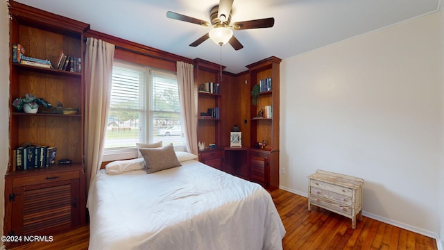 bedroom with ceiling fan and dark hardwood / wood-style flooring