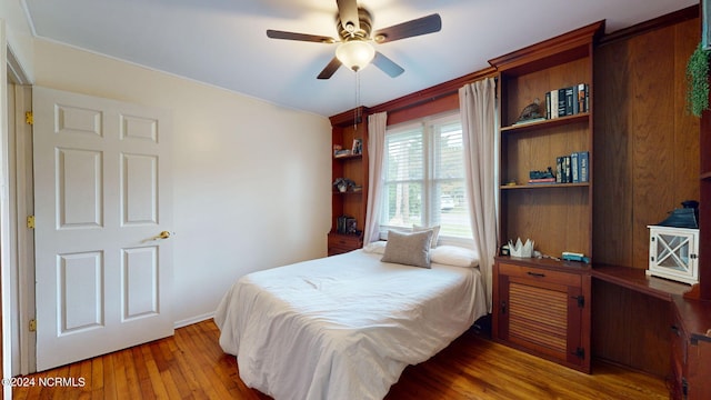 bedroom with light hardwood / wood-style floors and ceiling fan