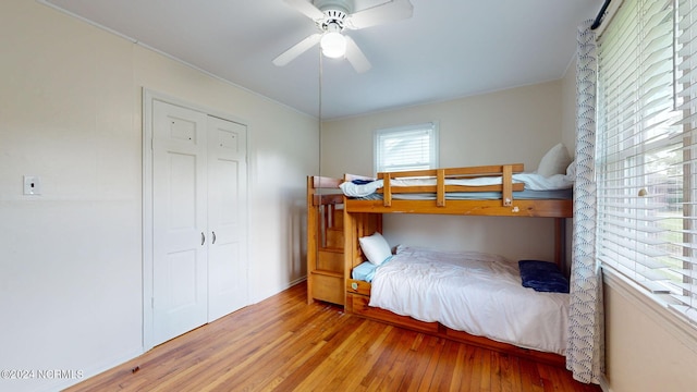 bedroom featuring ceiling fan, hardwood / wood-style flooring, and a closet